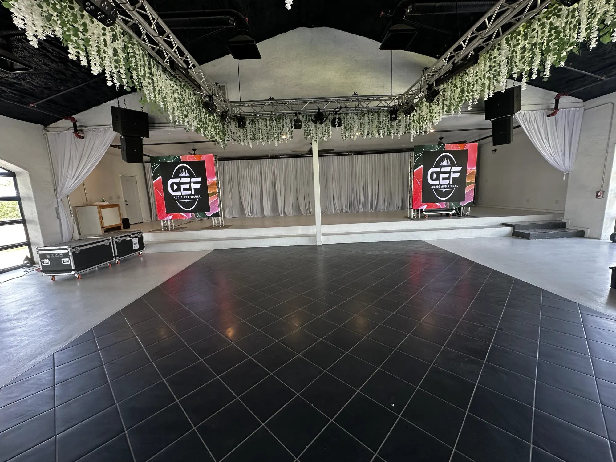 Two CEF LED walls flanking the stage at an event venue
